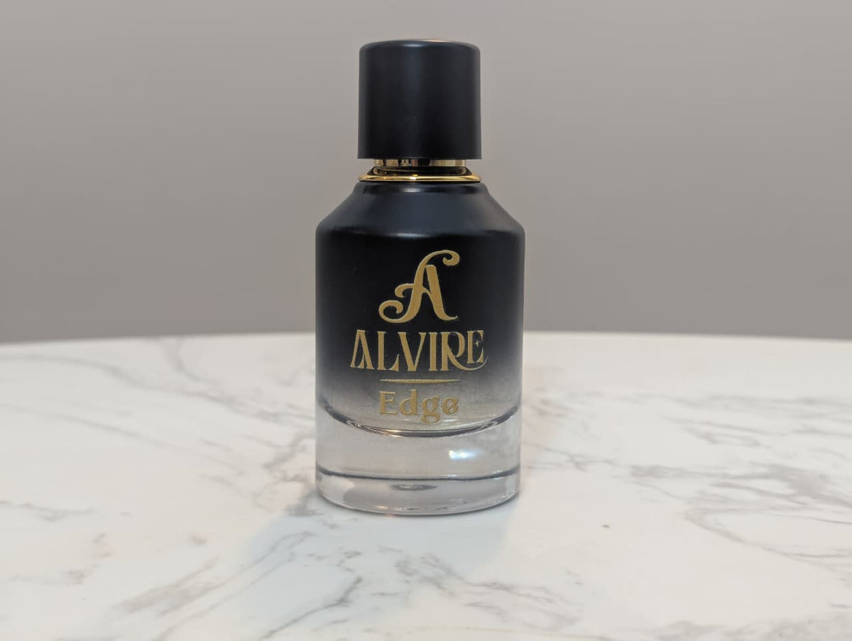 ALVIRE Edge 50 ml perfume bottle fading from black to clear on a marble table