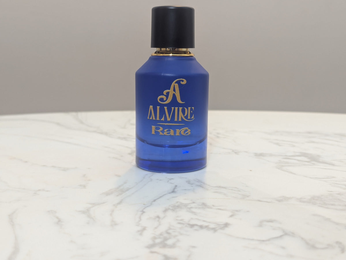 ALVIRE Rare 50 ml perfume bottle in deep blue glass on a marble table